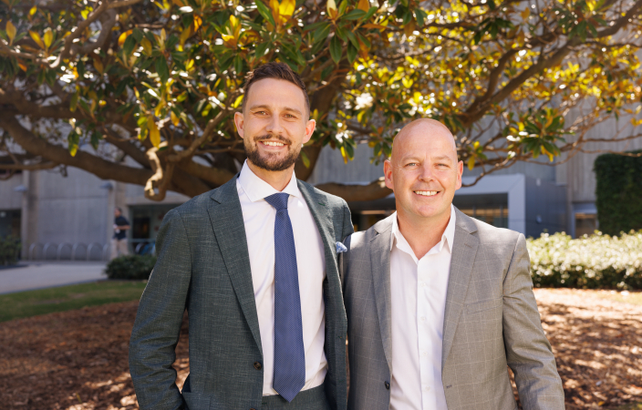 Two men standing side by side