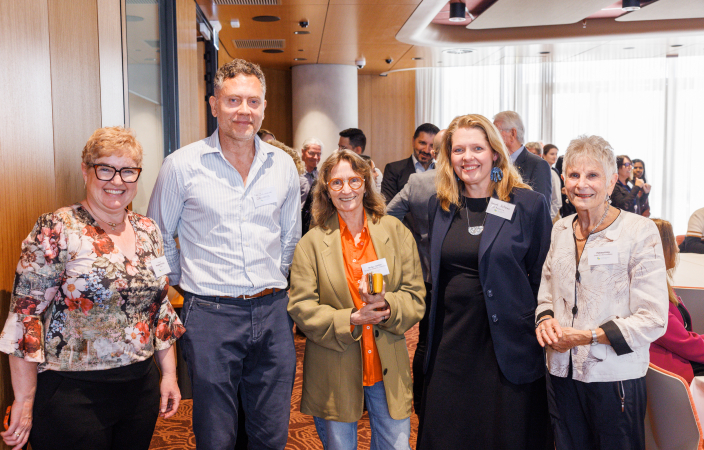 Five awards participants stand next to each other smiling