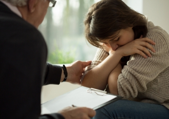 Psychologist comforting his depressed patient