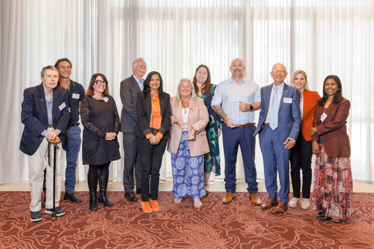 Winners stand with the advisory committee.
